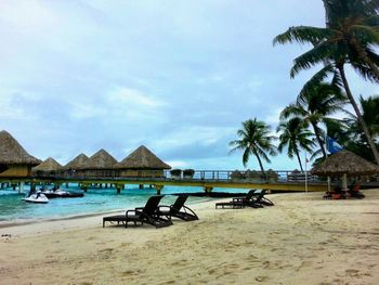 Scenic view of beach against cloudy sky