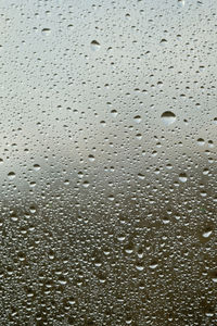Full frame shot of raindrops on glass window