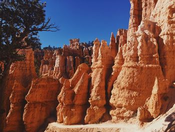 View of rock formation against clear blue sky