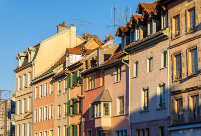 Low angle view of buildings against blue sky