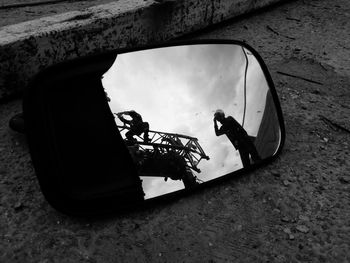 Reflection people on side-view mirror