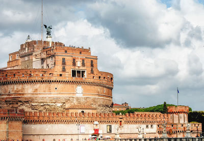 Low angle view of historical building against cloudy sky