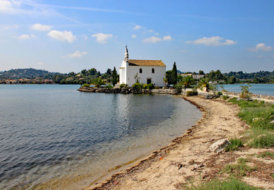 Buildings on beach against cloudy sky