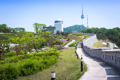 Footpath amidst buildings in city