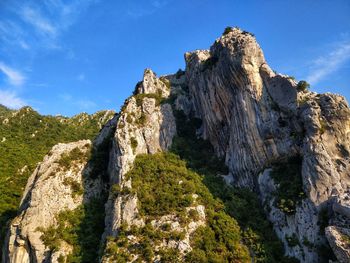 Low angle view of rock formations against sky