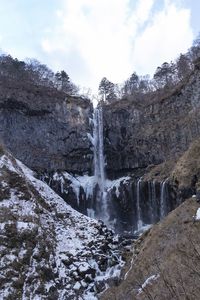 Scenic view of waterfall against sky