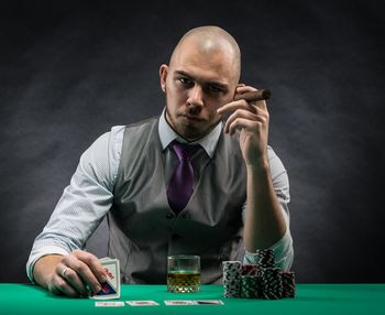 Portrait of man playing with cards at table