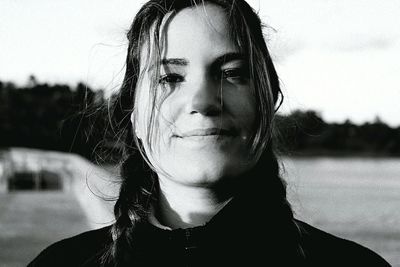 Close-up portrait of young woman with braided hair