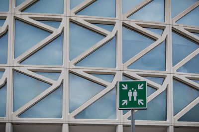 Low angle view of information sign against building