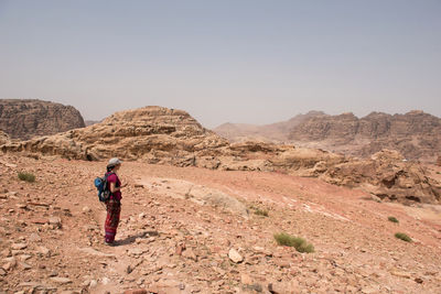 Rear view of man on mountain against sky