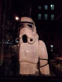 Close-up of statue against illuminated building at night