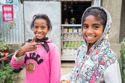 Portrait of smiling girl standing outdoors