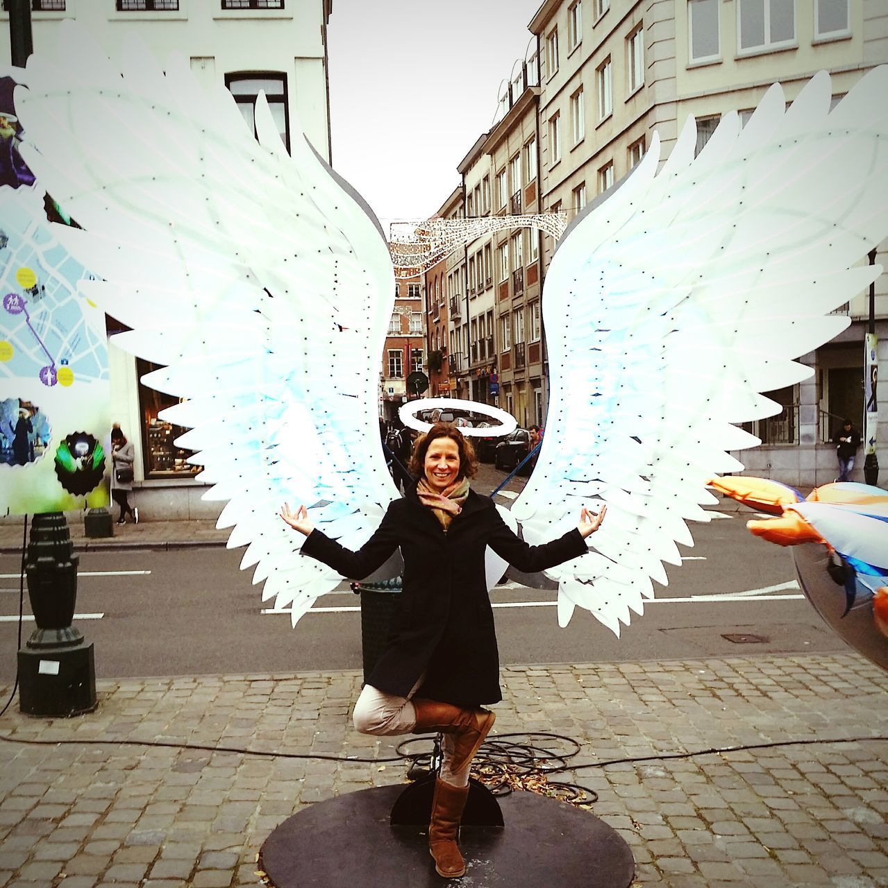 FULL LENGTH PORTRAIT OF HAPPY GIRL IN CITY AGAINST SKY