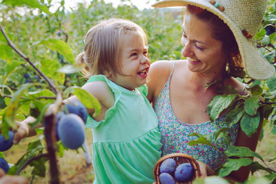 Close-up of smiling girl and plants