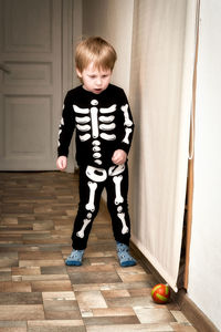 Full length of boy sitting on floor at home