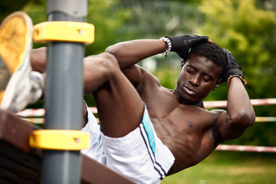 Low angle view of man exercising in playground