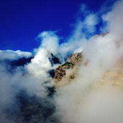 Low angle view of mountain against blue sky