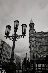 Low angle view of buildings against cloudy sky