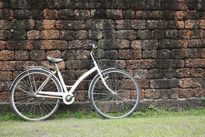 Bicycle leaning against wall