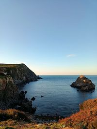 Scenic view of sea against clear blue sky