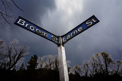 Low angle view of roadsign against sky