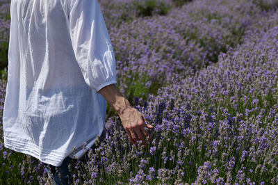 Middle aged woman walking in lavender field