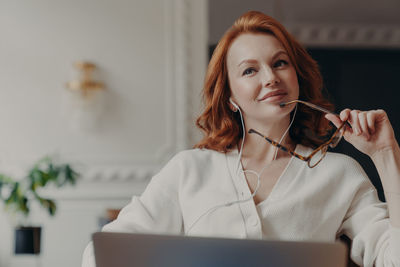 Portrait of young woman using mobile phone