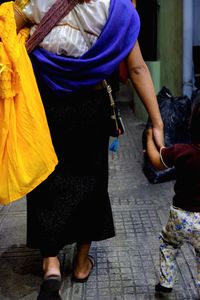 Rear view of woman and child on road