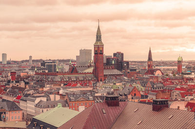 High angle view of buildings against cloudy sky