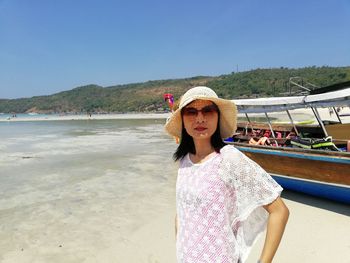 Portrait of woman standing at beach