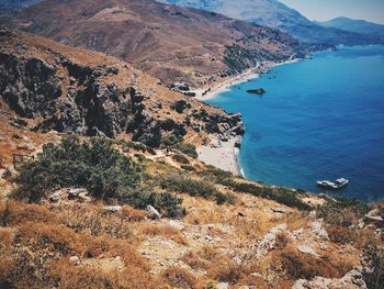 Aerial view of sea and mountains against sky