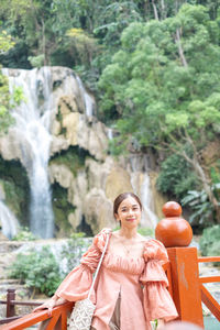 Portrait of woman sitting on rock