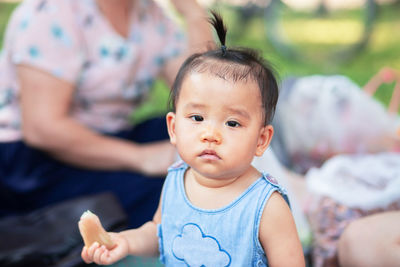 Portrait of cute baby girl and mother in background