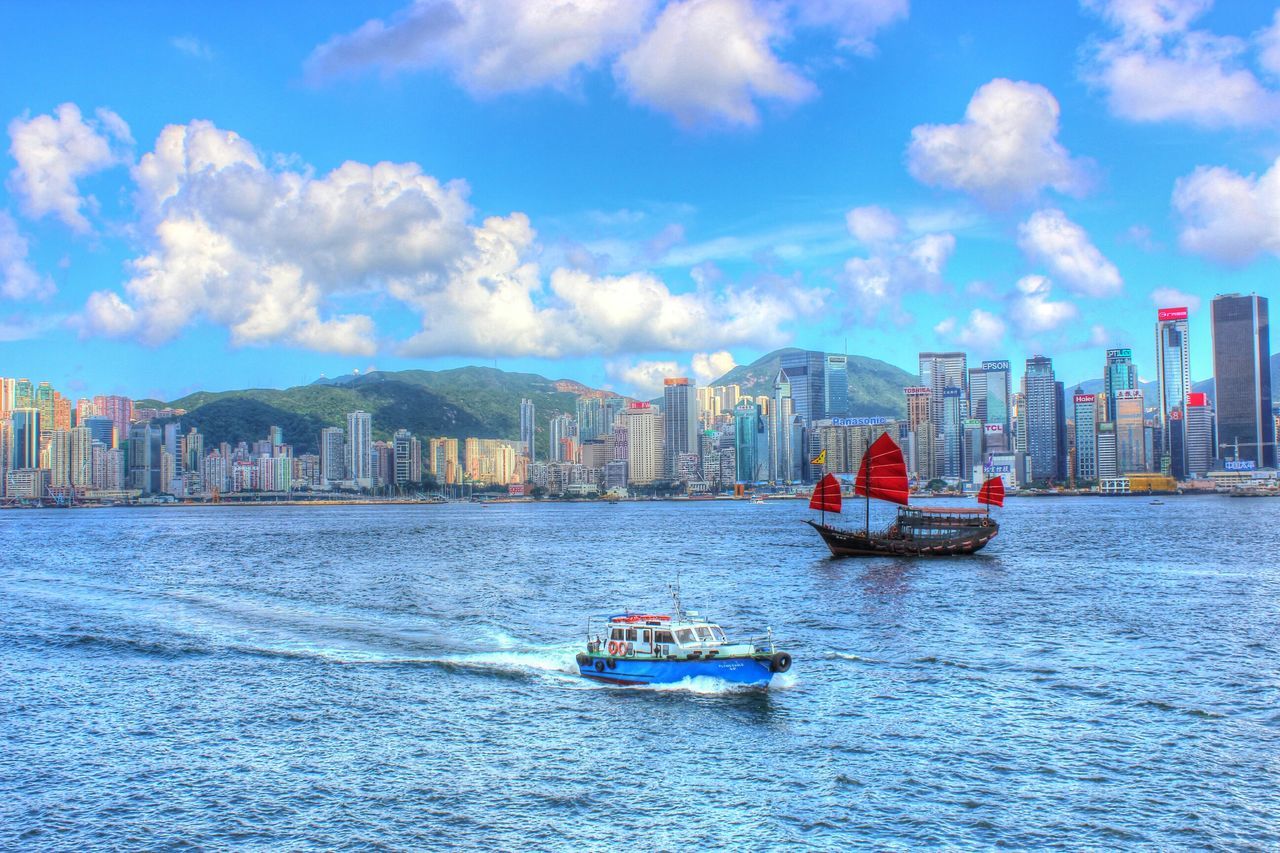 nautical vessel, transportation, boat, mode of transport, water, waterfront, sky, architecture, building exterior, built structure, sea, blue, city, cloud - sky, travel, cloud, river, moored, day, sailing