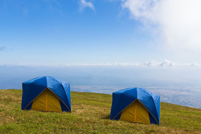 Scenic view of tent on field against sky