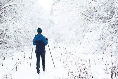 Rear view of man on snow covered land