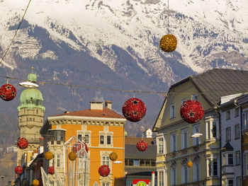 Low angle view of lanterns hanging by building in city