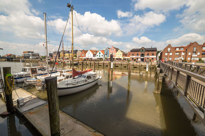 Boats moored in harbor in city