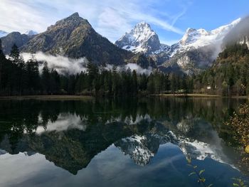 Scenic view of lake and mountains against sky