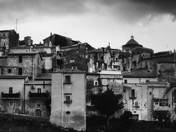 High angle view of old buildings in town against sky