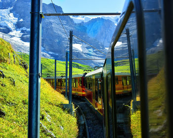 Train on railroad track by mountains