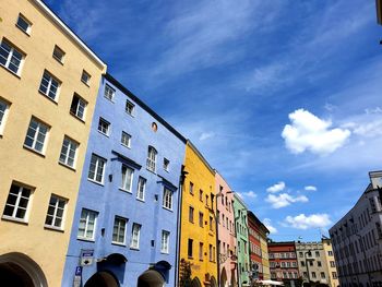 Low angle view of buildings in town against sky