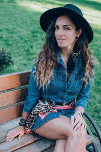 Portrait of beautiful stylish young woman wearing black felt hat smiling millennials generation.