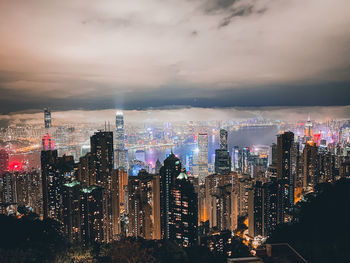 Illuminated cityscape against sky at night