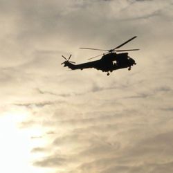 Low angle view of helicopter flying against sky