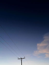 Low angle view of airplane flying against sky during sunset