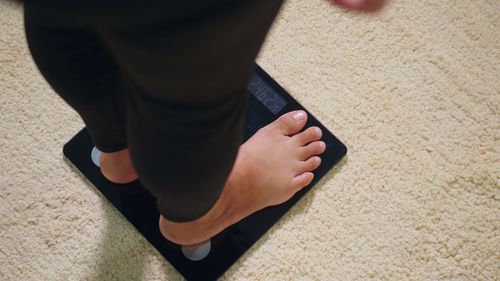 Low section of man standing on mobile phone