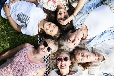 Top view of happy group of women lying in a meadow