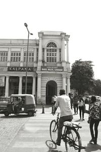 People on street in city against clear sky