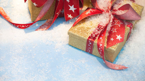 High angle view of christmas presents with snow on floor